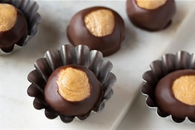 Buckeye candies are peanut butter balls dipped in chocolate