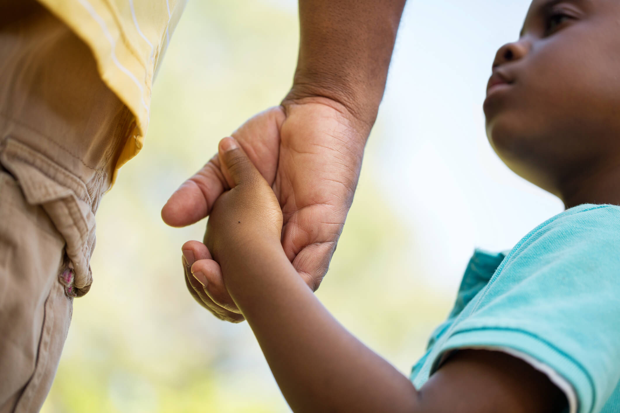 Volunteer-with-young-boy-holding-hands.jpg