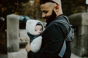 Father with child in baby carrier