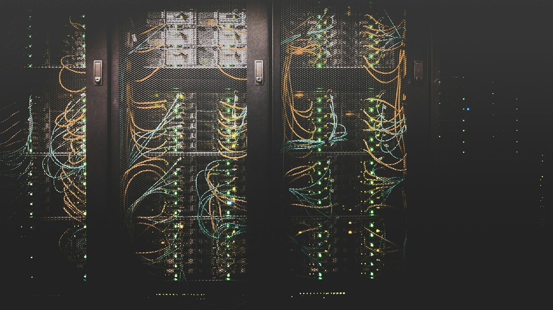 Photo of digital equipment racks in a server room; photo by Taylor Vick on Unsplash