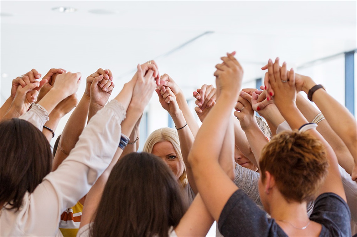 women-united-holding-hands-in-air.jpg