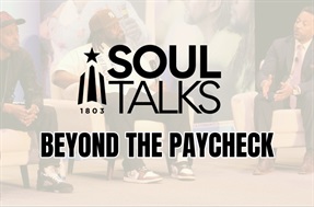 Soul Talks event graphic reading ‘Beyond the Paycheck,’ with the Franklin County 1803 logo. In the background, a panel discussion with three men seated on stage speaking into microphones.