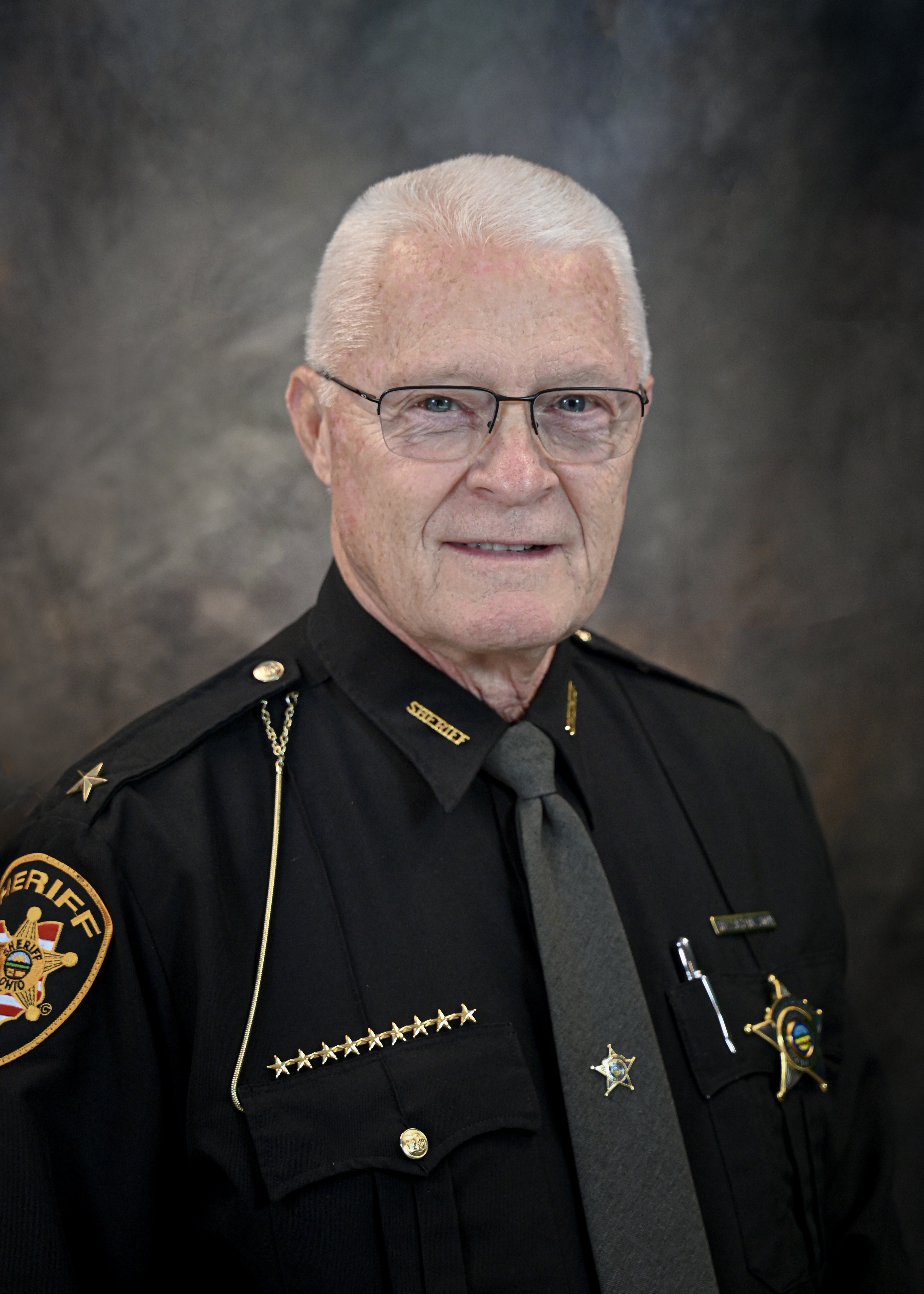 Photo of Sheriff Dalas Baldwin in uniform in front of a grey background