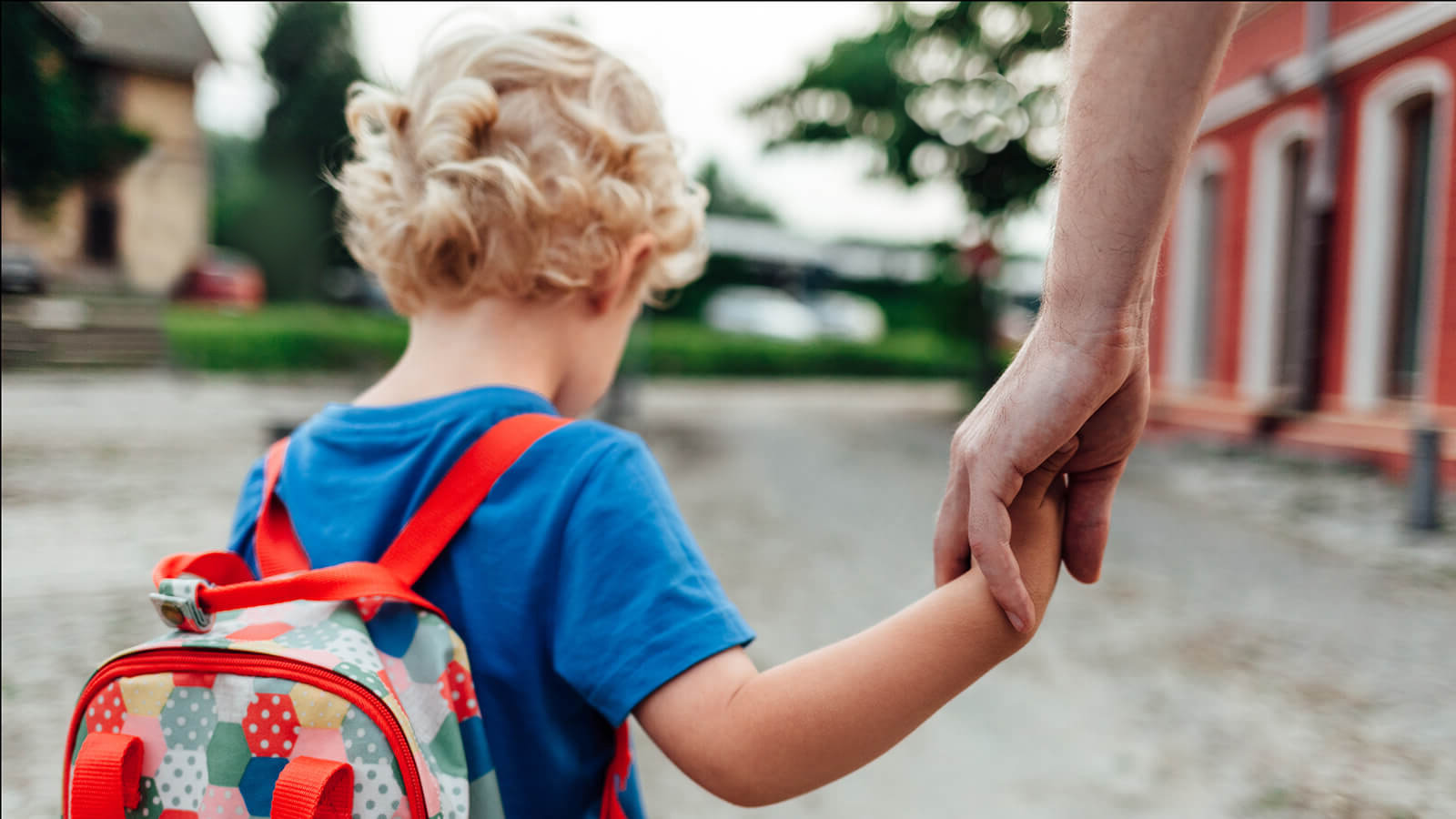 Boy holding hands with volunteer. 